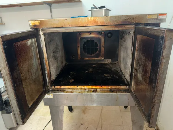Open commercial oven during detailed cleaning