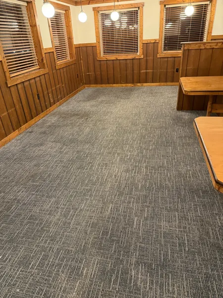 Dining room floor beside wood-paneled booths