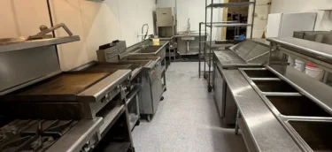 Commercial kitchen aisle and stainless work surfaces