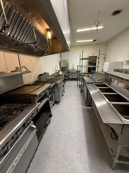 Commercial kitchen aisle and stainless work surfaces