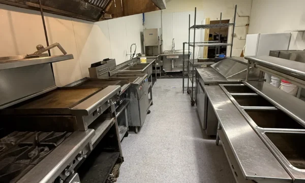 Commercial kitchen aisle and stainless work surfaces