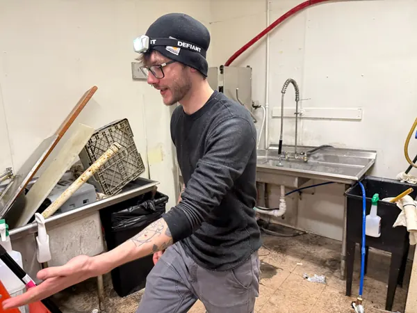 Crew member working on kitchen equipment