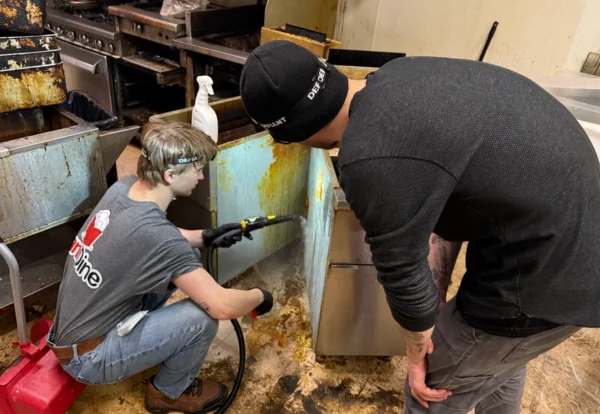 Two crew members cleaning equipment